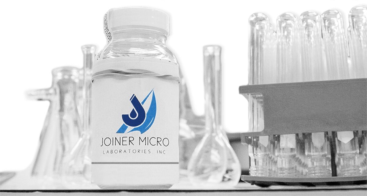 Joiner Micro Laboratories water sample bottle among lab glassware