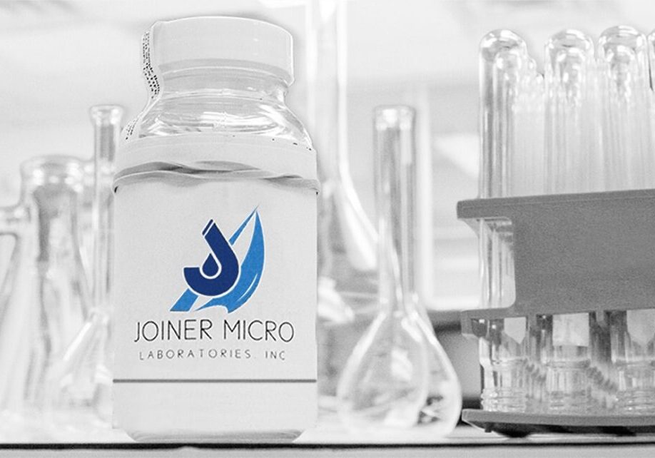 Joiner Micro Laboratories water sample bottle among lab glassware